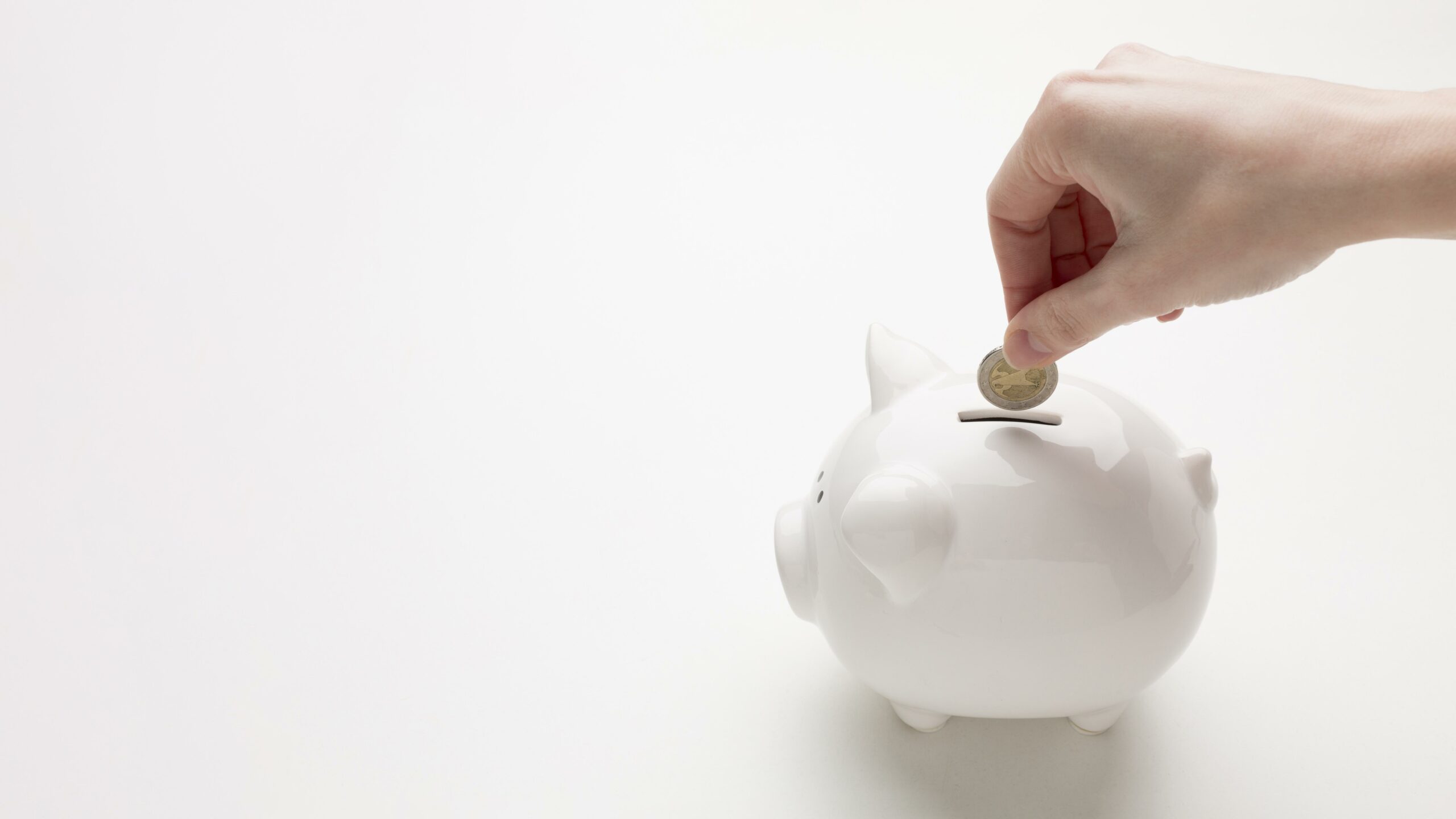 Piggy bank with coins illustrating savings on discount cigarette cartons